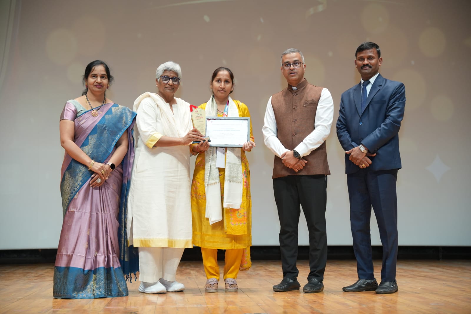 Mrs. Pagadala Roja receiving the HSSC Celebrity Teacher Award
