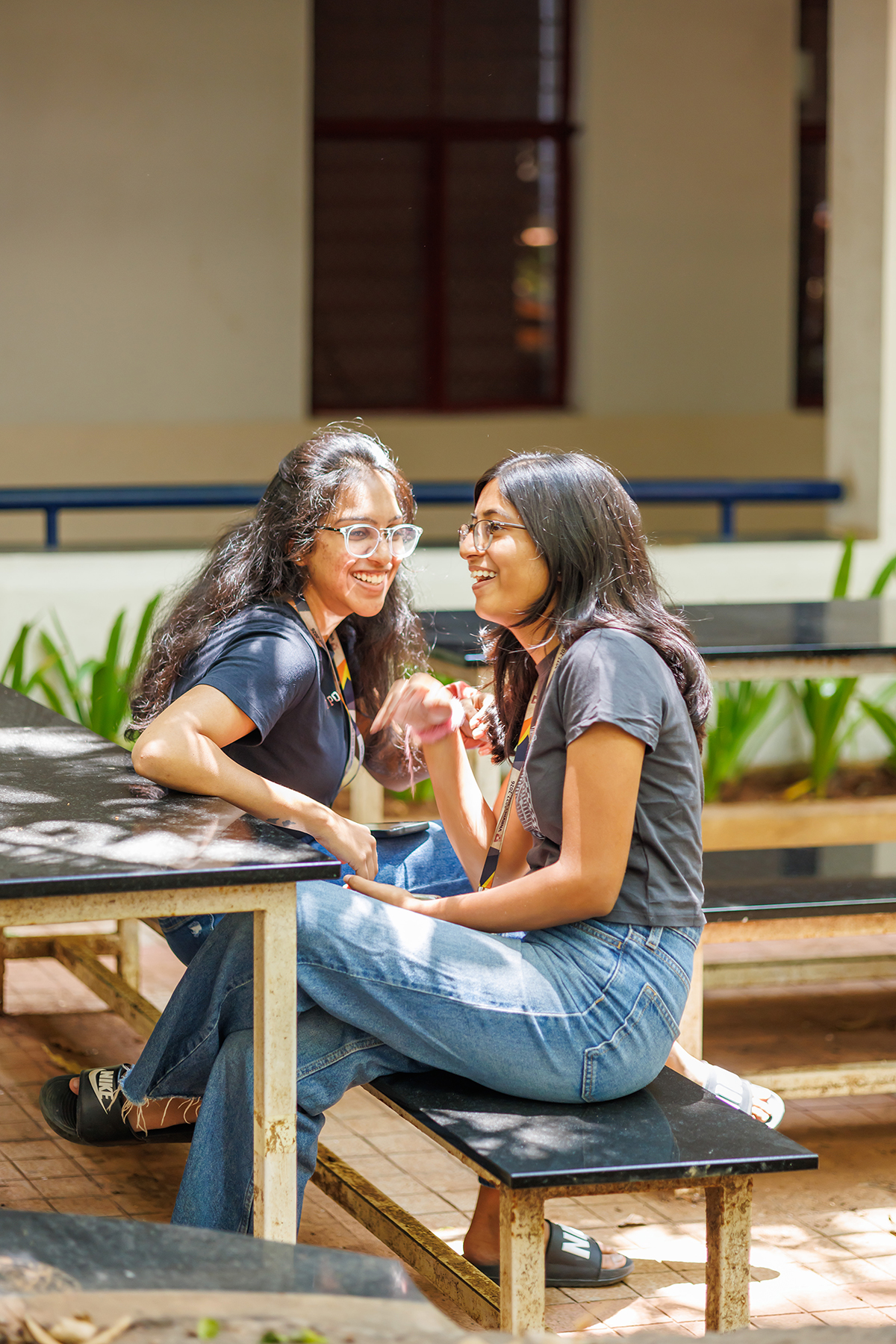 Students talking together on a bench in the VJPS courtyard